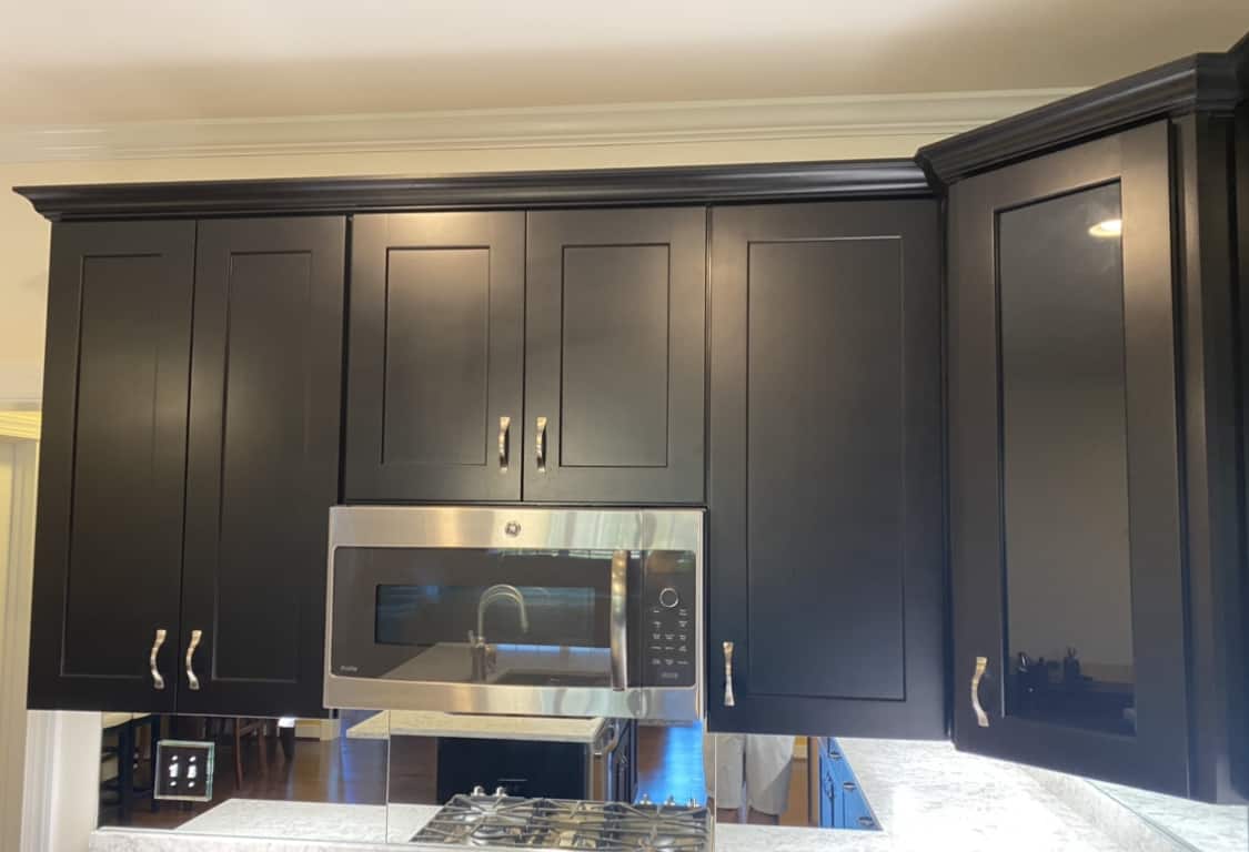Skilled house painter with their dark brown cabinet painting in Williamsburg.